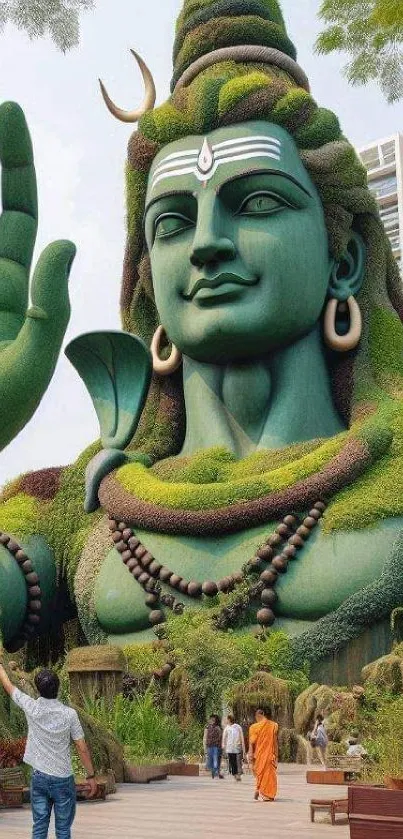 Majestic green Shiva statue amidst nature, offering tranquility.