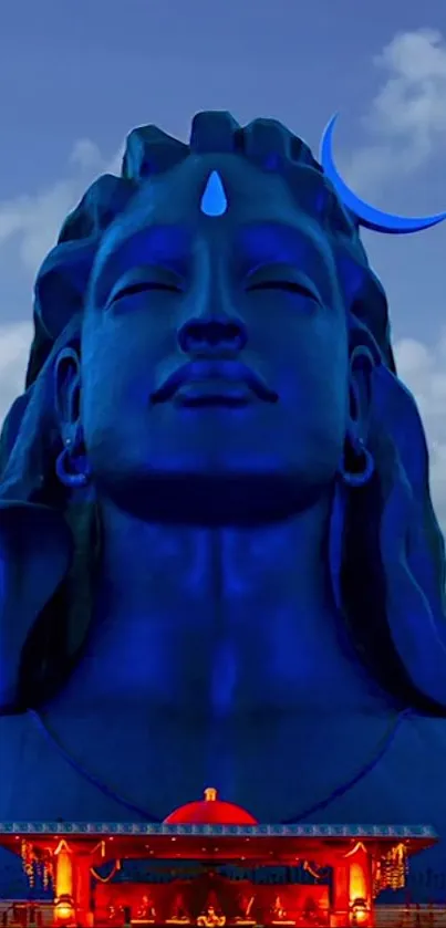 Majestic Shiva statue with night sky in blue tones, adding a mystical touch.