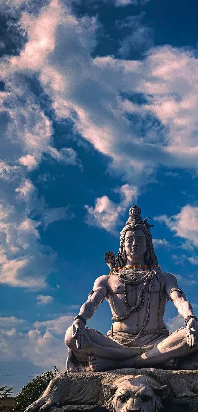 Shiva statue with vibrant clouds and sky backdrop.