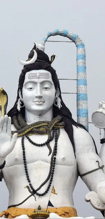 Majestic white Shiva statue with trident and serene expression.