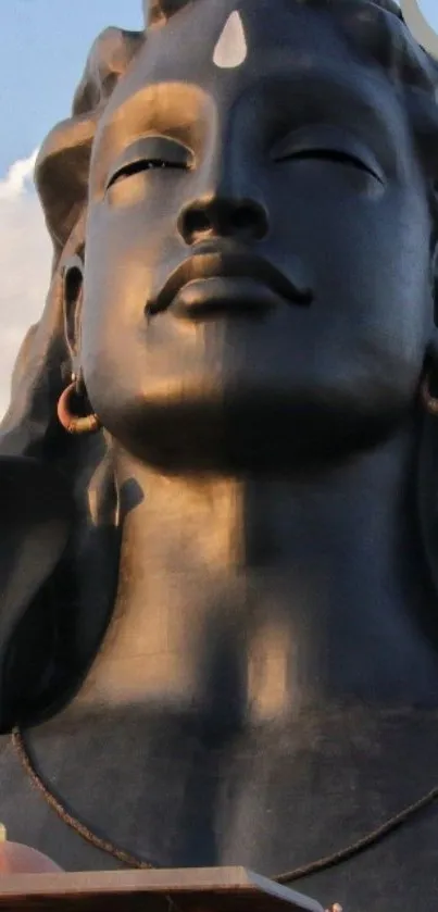 Majestic Shiva statue against a serene sky.