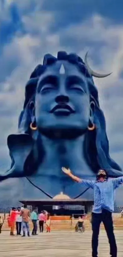 Majestic blue Shiva statue under a vibrant sky.