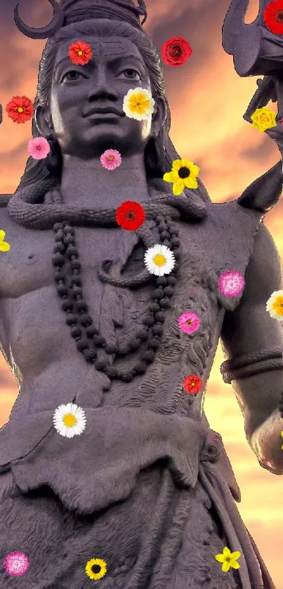 Shiva statue with colorful flowers at sunset, perfect for mobile wallpaper.