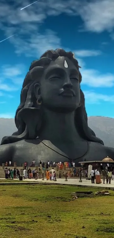 Majestic Shiva statue with blue sky and green landscape in stunning HD.