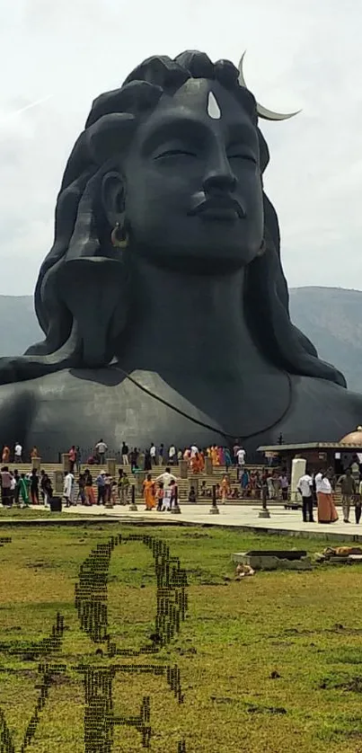 Majestic Shiva statue with a serene backdrop and LOVE text on grass.