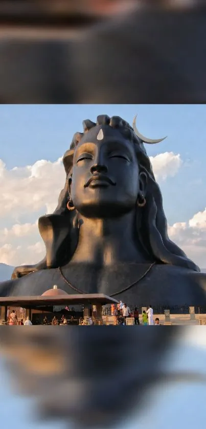 Majestic Adiyogi Shiva statue with blue sky and clouds.