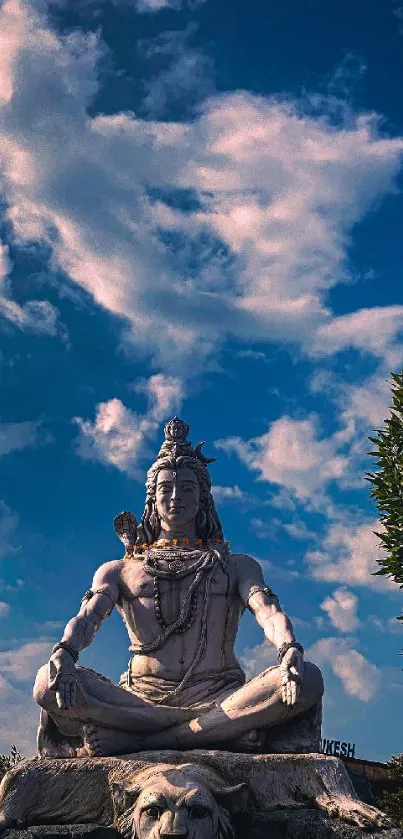 Shiva statue meditating under a cloudy sky with a serene ambiance.