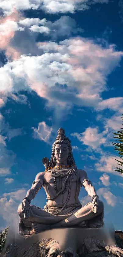 Lord Shiva statue with cloudy blue sky background.