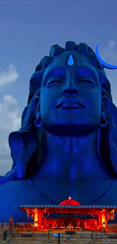 Majestic blue Shiva statue under a serene sky.