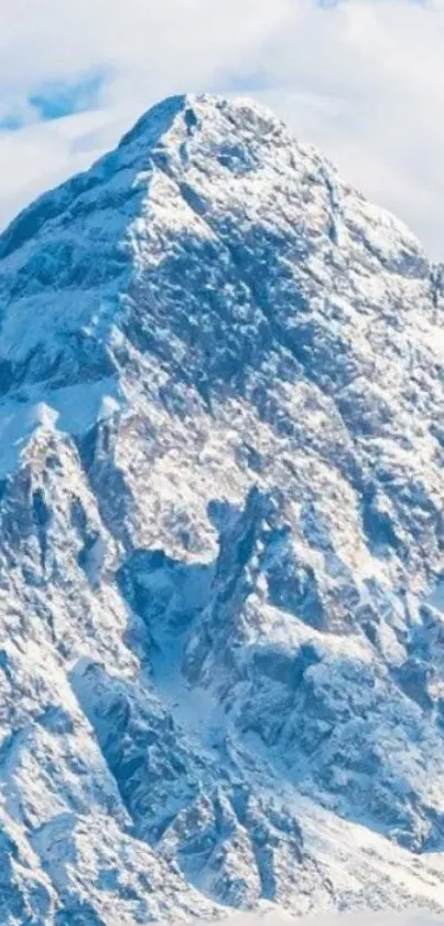 Majestic snow-capped mountain with vibrant blue sky.