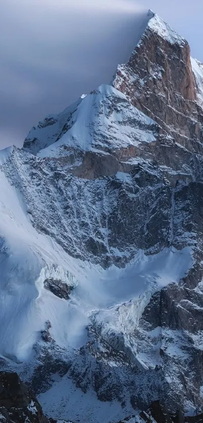 A majestic snow-covered mountain peak under a clear sky.