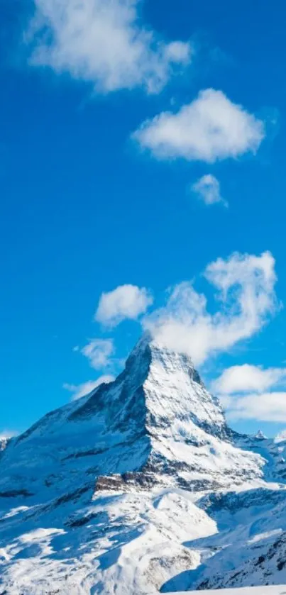 Majestic mountain peak under a blue sky with white clouds.