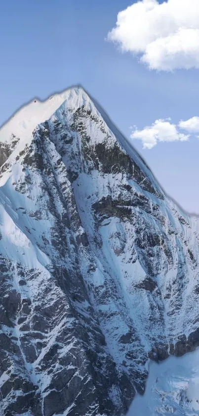 Snowy mountain peak with blue sky and clouds.