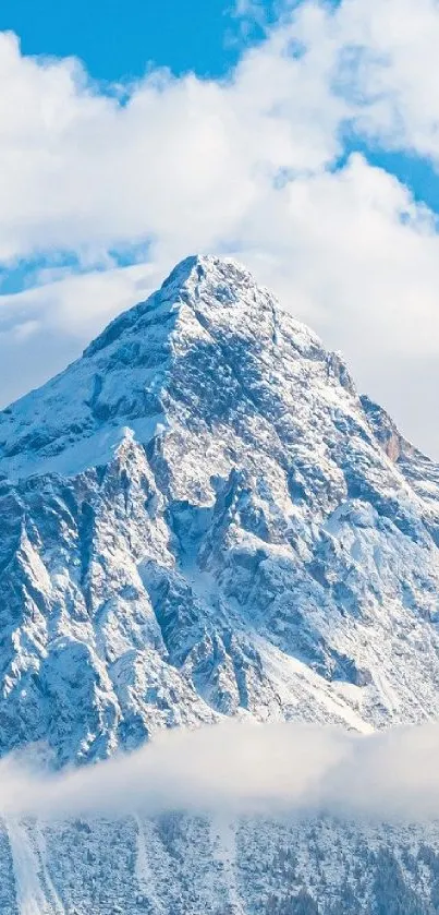 Majestic snow-capped mountain with blue sky and clouds.