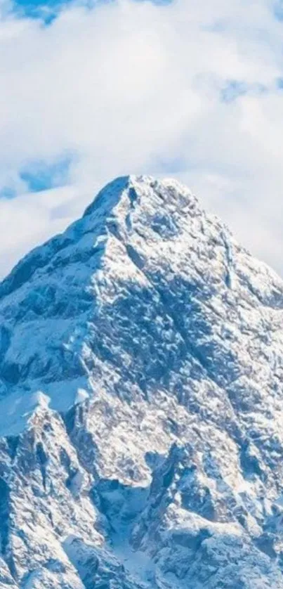 Snowy mountain peak under blue sky.