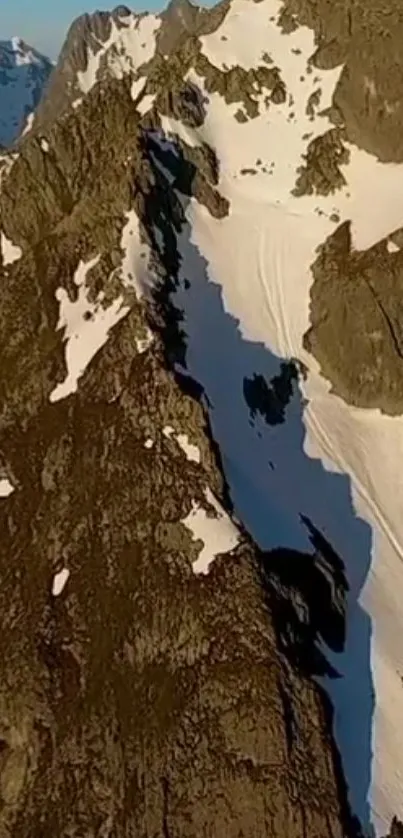 Breathtaking view of snowy mountain peaks under blue sky.