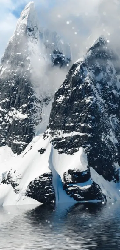 Snowy mountain peaks under a clear sky reflecting in calm waters.