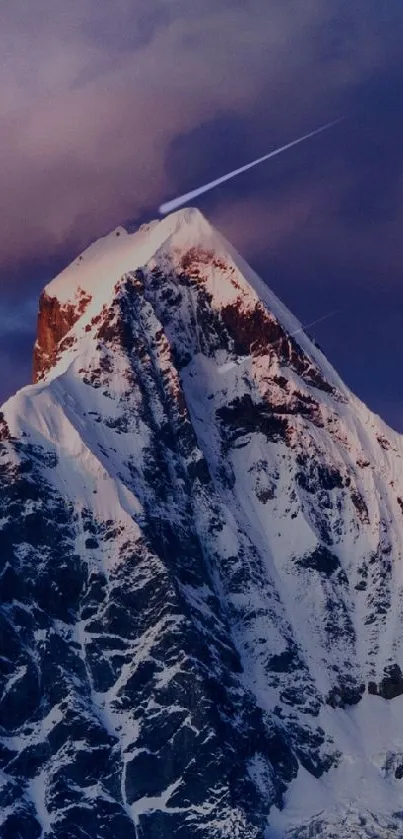 Snow-capped mountain peak under vibrant sky.