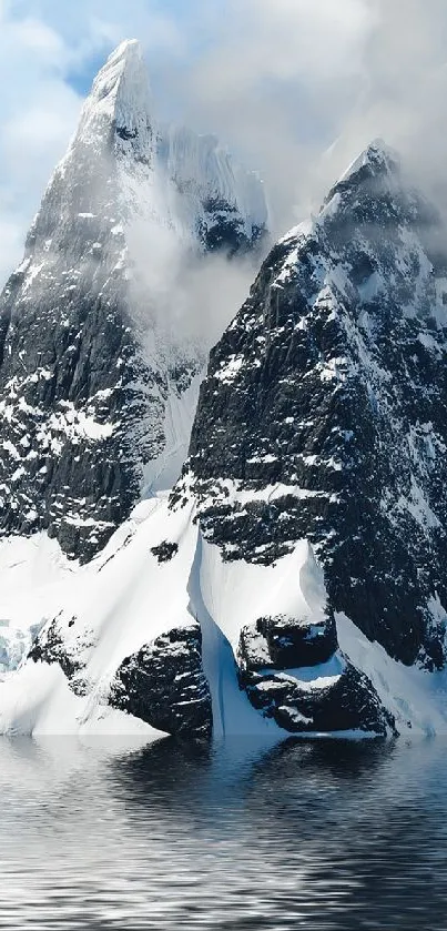 Snowy mountain peaks reflected in tranquil water.