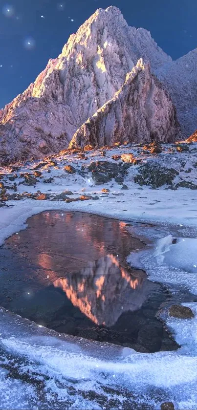 Snowy mountain with ice pond reflecting sunset hues.