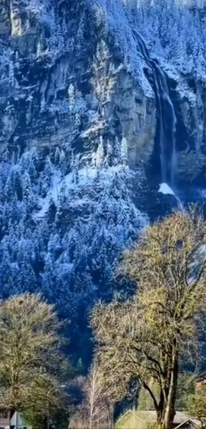 Beautiful snowy mountain with waterfall and trees, perfect for mobile wallpaper.