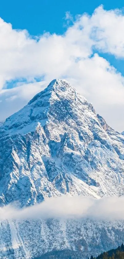 Snowy mountain under a clear blue sky with clouds.