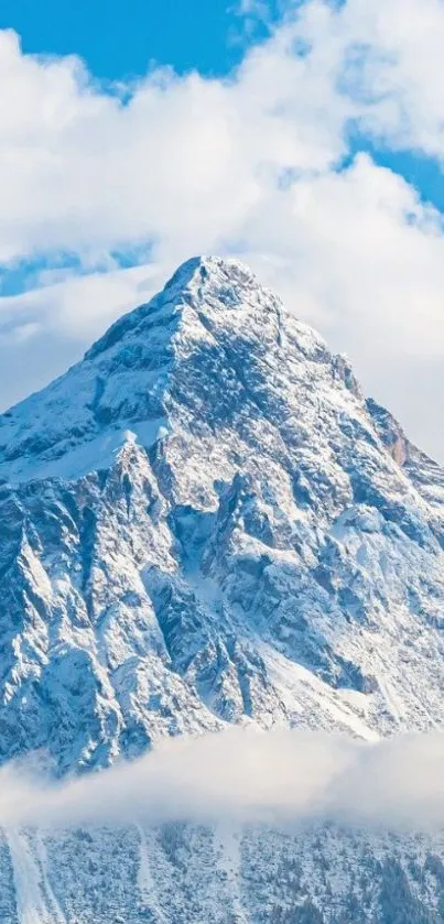 Snowy mountain peak beneath blue sky background.