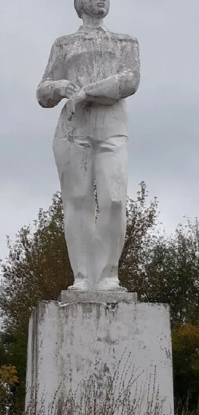 Majestic white statue against a cloudy sky backdrop.