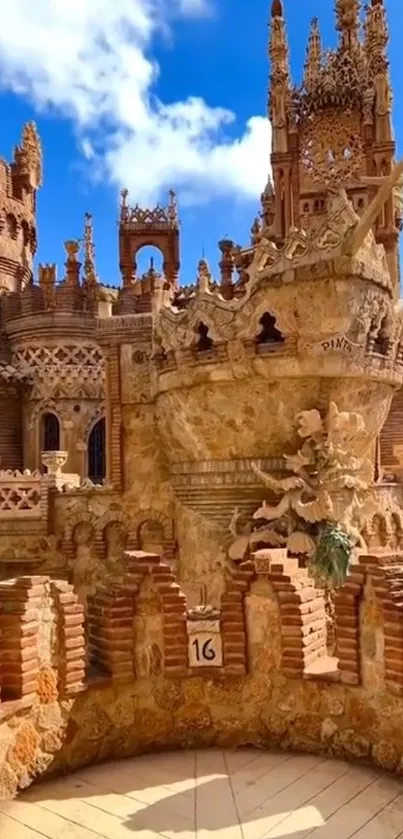 Intricate stone castle with blue sky backdrop.