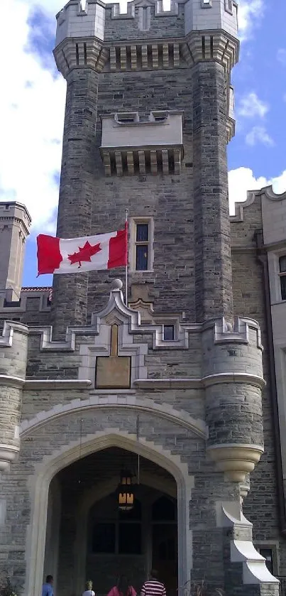 Stone castle with Canadian flag and blue sky backdrop.