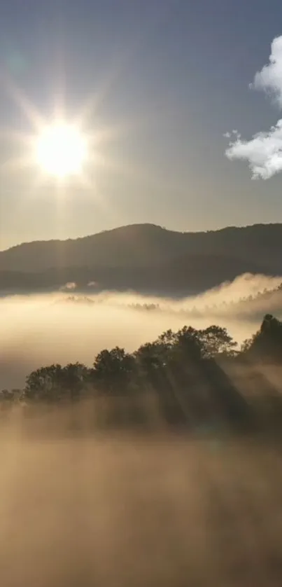 Sunrise over misty mountains with clouds and sunlight rays.