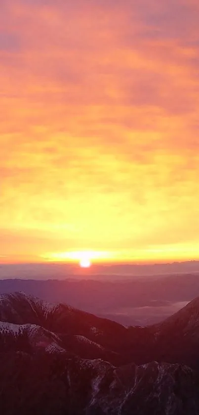 Sunrise casting orange hues over jagged mountain peaks.