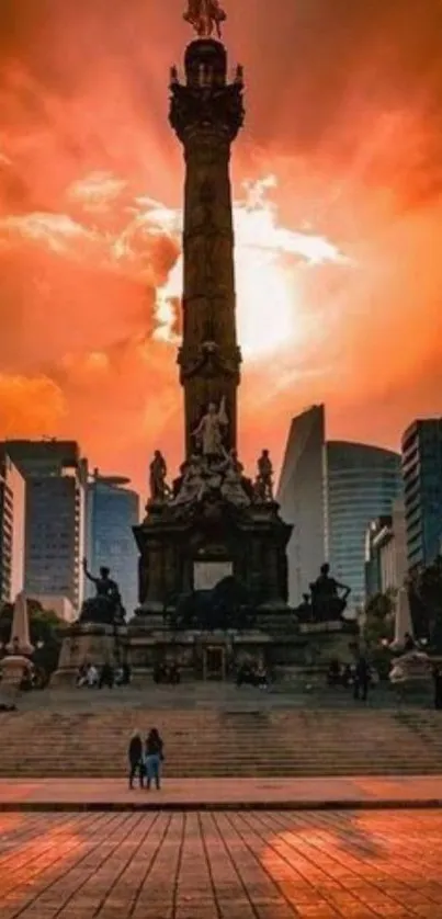 Majestic sunset silhouette of city angel monument with vibrant orange sky.