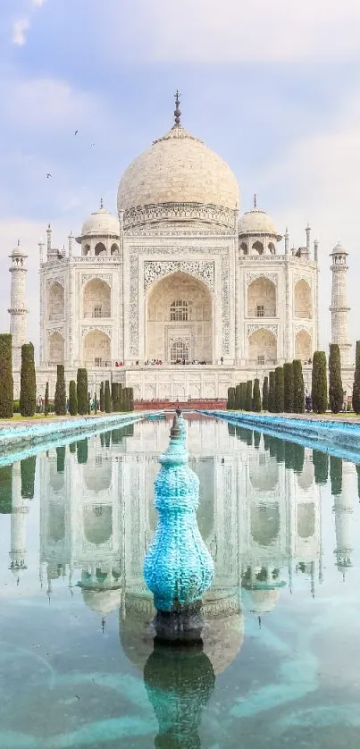 Taj Mahal with reflection in calm water and a blue sky backdrop.