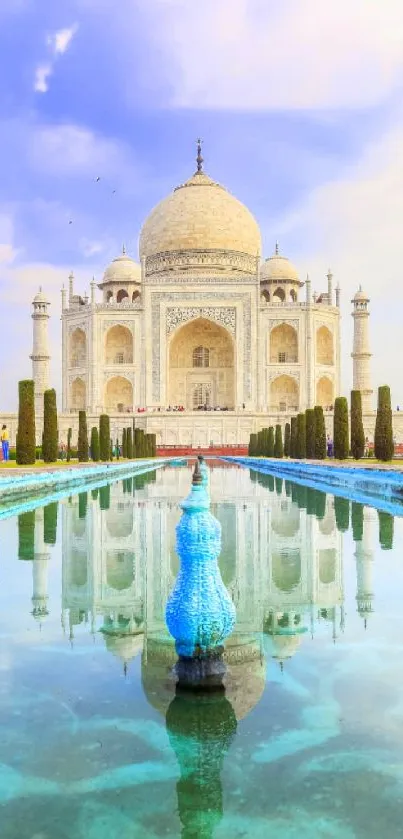 Taj Mahal with its reflection in a serene water setting, under a blue sky.