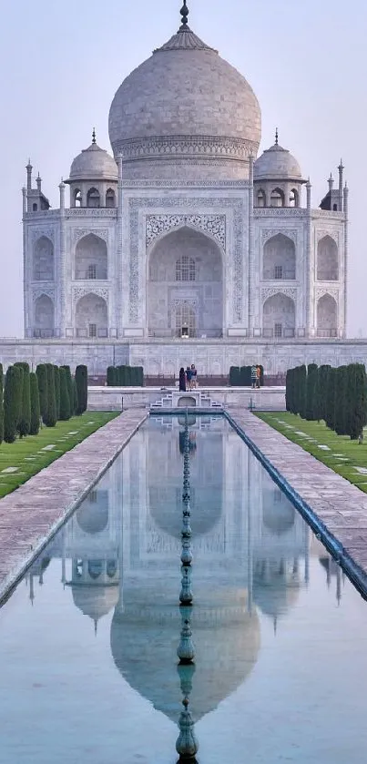 Majestic view of Taj Mahal with reflection pool and lush gardens.