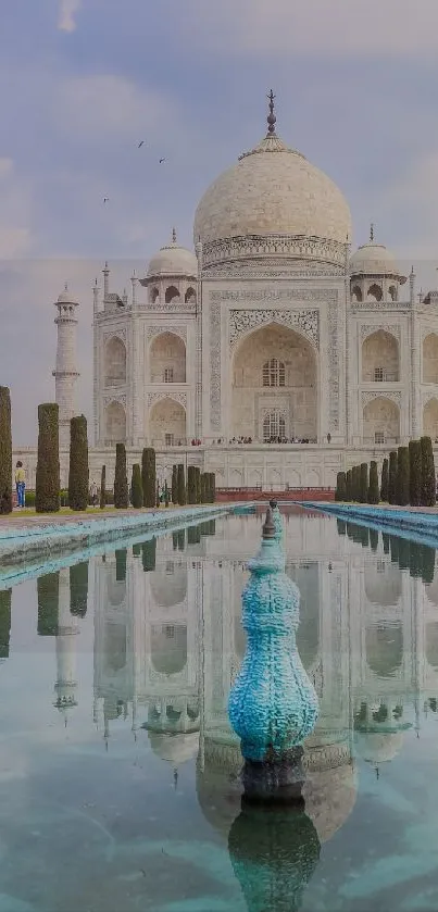 Taj Mahal with reflective water and clear sky.