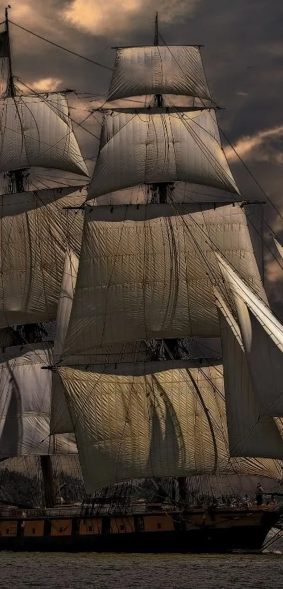 Tall ship with dramatic sails at sunset.