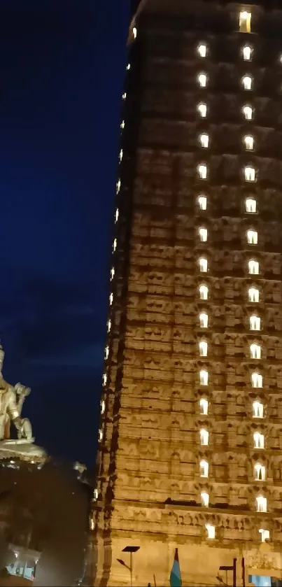 Majestic temple illuminated at night with deep blue sky backdrop.