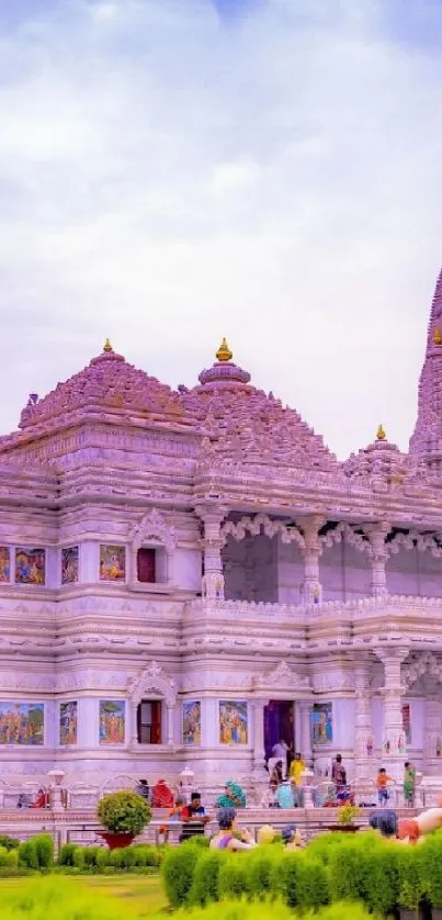 Majestic temple with ornate details and people visiting on a peaceful day.