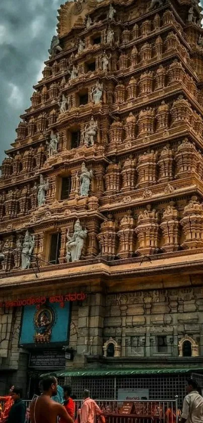 Majestic temple tower with intricate carvings against a dramatic sky.