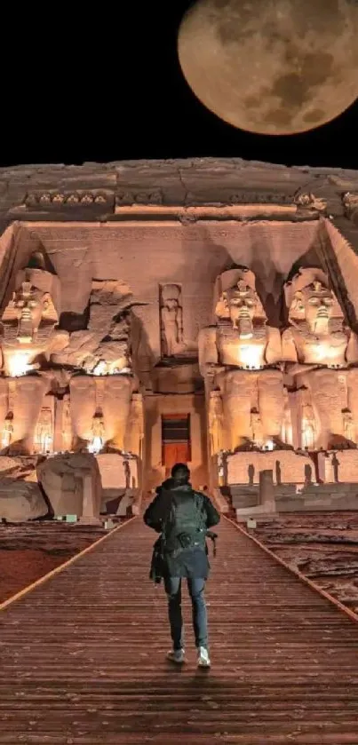 Person walking towards an ancient temple under a full moon.