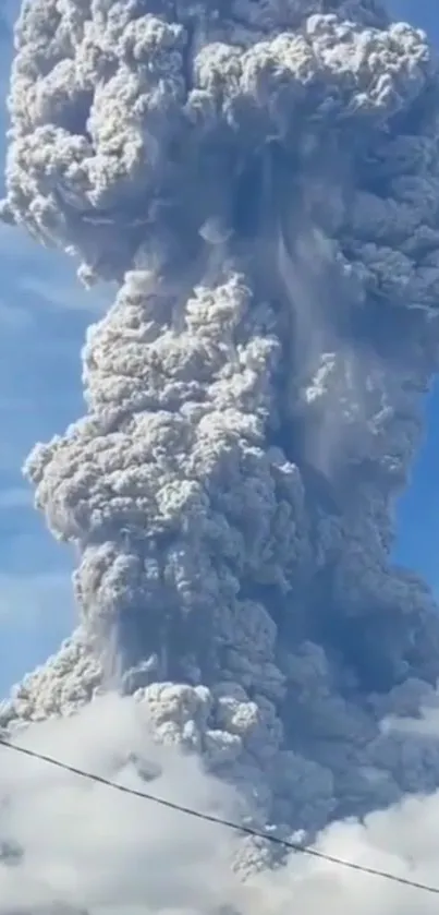 Volcanic eruption amidst a vibrant blue sky.