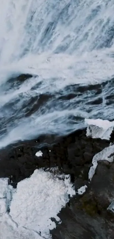 Aerial view of a majestic waterfall cascading down rocks.