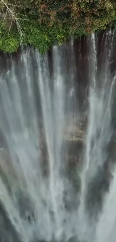 A breathtaking view of a waterfall cascading through lush green forest.