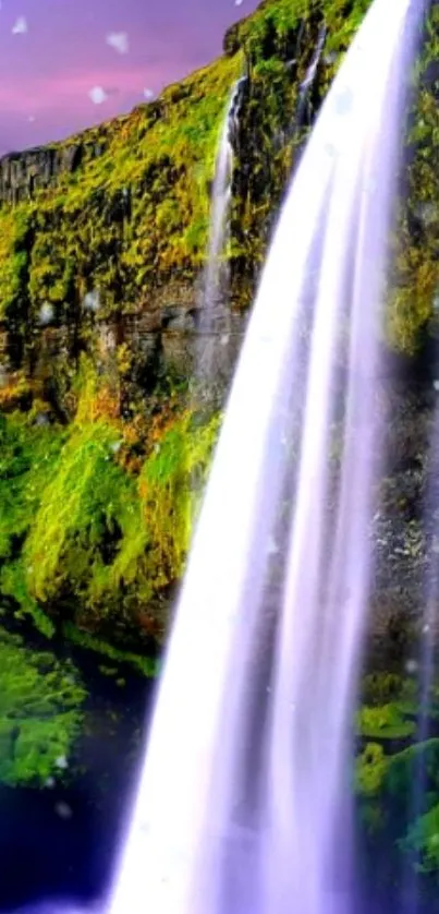 Waterfall with lush green landscape and cascading water.