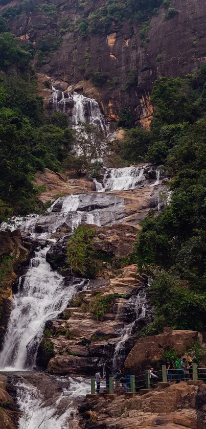 Stunning waterfall cascading over rocks with lush green surroundings.