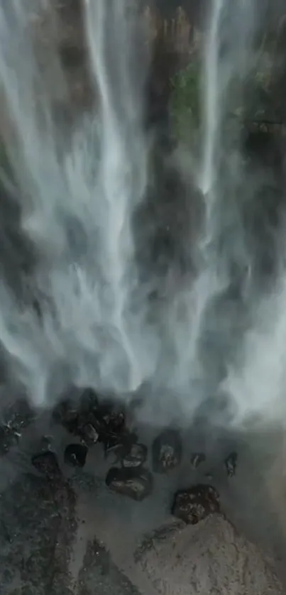 Majestic waterfall cascades over rocks.