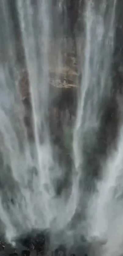 Majestic waterfall cascading down rocks in a vertical shot.