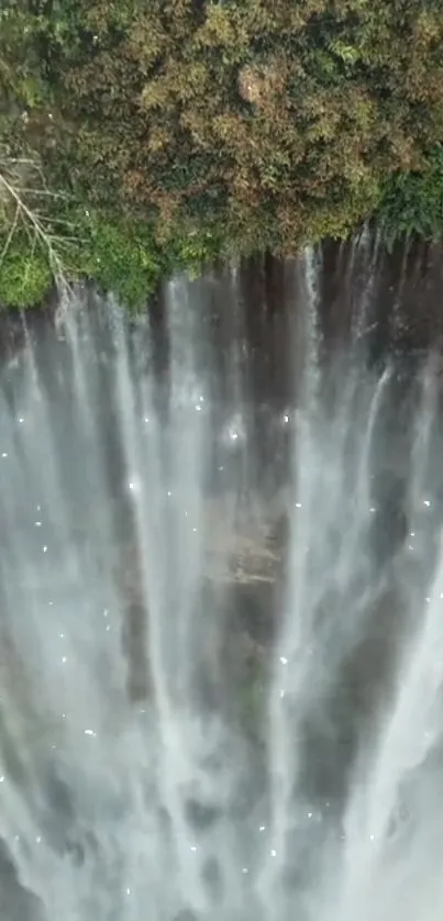 Beautiful waterfall cascading down lush green cliffs.